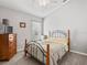 Comfortable bedroom with carpet flooring, a bed with wooden frame and light gray walls at 903 Tramells Trl, Kissimmee, FL 34744