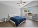 Bright bedroom with hardwood floors, vaulted ceiling, and a comfortable bed with a blue comforter at 903 Tramells Trl, Kissimmee, FL 34744