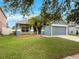 Charming single-story home with a well-maintained lawn and palm trees at 903 Tramells Trl, Kissimmee, FL 34744