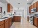 Spacious kitchen featuring tile flooring, stainless steel appliances, and ample cabinet space at 903 Tramells Trl, Kissimmee, FL 34744