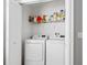 Bright laundry room featuring a stacked washer and dryer and wire shelving at 903 Tramells Trl, Kissimmee, FL 34744