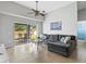 Comfortable living room with gray sectional and natural light, leading to a patio and backyard view at 903 Tramells Trl, Kissimmee, FL 34744
