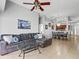 Cozy living room featuring a large gray sectional sofa and an open layout into the dining area at 903 Tramells Trl, Kissimmee, FL 34744
