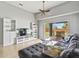 Comfortable living room featuring a gray sofa, built-in shelves, and sliding glass doors to the patio at 903 Tramells Trl, Kissimmee, FL 34744