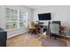 Home office with a large window, two desks, and neutral walls at 903 Tramells Trl, Kissimmee, FL 34744
