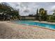 Large community pool with ample lounge seating and manicured landscaping creating an inviting recreational space at 907 Sussex Close # 4, Orlando, FL 32804
