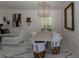 Bright dining area with a modern chandelier, elegant furnishings, and marble flooring at 907 Sussex Close # 4, Orlando, FL 32804