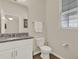 Bathroom featuring a granite-topped vanity, light wood-look flooring, and neutral paint at 11006 Sound Shore Dr, Winter Garden, FL 34787
