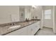 Bathroom featuring a long vanity with double sinks and granite countertops at 11006 Sound Shore Dr, Winter Garden, FL 34787
