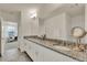Spacious bathroom with double sinks, granite counters, white cabinets, and tile floor at 11006 Sound Shore Dr, Winter Garden, FL 34787