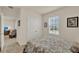 Bright bedroom featuring a window and double doors with entry to another room at 11006 Sound Shore Dr, Winter Garden, FL 34787