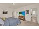Bedroom featuring a comfortable bed, a TV on a wooden dresser, and two entry doorways at 11006 Sound Shore Dr, Winter Garden, FL 34787