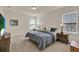 Relaxing bedroom with soft carpet, dual windows, and modern furnishings at 11006 Sound Shore Dr, Winter Garden, FL 34787