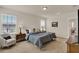Bright bedroom with a large window, two bedside tables, and a comfortable armchair at 11006 Sound Shore Dr, Winter Garden, FL 34787