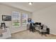 Bedroom with two windows, carpeted floor, and a desk setup with multiple monitors at 11006 Sound Shore Dr, Winter Garden, FL 34787