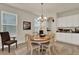 Cozy dining room featuring a round table, neutral paint, wood-look flooring, and natural light at 11006 Sound Shore Dr, Winter Garden, FL 34787