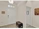 Inviting foyer featuring wood-look tile flooring, a bench, and neutral paint throughout at 11006 Sound Shore Dr, Winter Garden, FL 34787