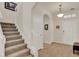 Welcoming foyer featuring wood-look tile flooring, a staircase, and neutral paint throughout at 11006 Sound Shore Dr, Winter Garden, FL 34787