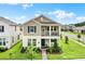 Charming two-story home showcasing a cozy front porch and beautiful, well-maintained landscaping at 11006 Sound Shore Dr, Winter Garden, FL 34787
