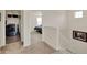 Upstairs hallway leading to bedroom with stairs on the side and a laundry closet at 11006 Sound Shore Dr, Winter Garden, FL 34787