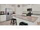 Bright kitchen featuring granite countertops, a stainless refrigerator, and a breakfast bar with seating at 11006 Sound Shore Dr, Winter Garden, FL 34787