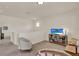 Upstairs living room area featuring a television, small table with chairs, and comfortable seating at 11006 Sound Shore Dr, Winter Garden, FL 34787