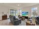 Spacious living room featuring a sliding door to the patio, modern furniture, and neutral decor at 11006 Sound Shore Dr, Winter Garden, FL 34787