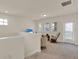 Upstairs living room area with neutral tones and natural light coming in from many windows at 11006 Sound Shore Dr, Winter Garden, FL 34787