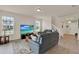 Comfortable living room with a large sofa, staircase, and view of the front yard at 11006 Sound Shore Dr, Winter Garden, FL 34787