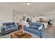 Open-concept living area with hardwood floors, an island kitchen, and comfortable sofas at 11006 Sound Shore Dr, Winter Garden, FL 34787
