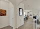 Open-concept layout showcasing the foyer, dining area, kitchen, and living area with wood-look tile flooring at 11006 Sound Shore Dr, Winter Garden, FL 34787