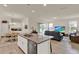 Bright and open layout of the kitchen, living room, and dining room with a view of the backyard at 11006 Sound Shore Dr, Winter Garden, FL 34787