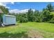 Spacious backyard with storage shed and lush greenery, perfect for outdoor activities at 1032 Silcox Branch Cir, Oviedo, FL 32765