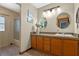 Bathroom featuring wood cabinets, granite countertop, and decorative mirrors at 1032 Silcox Branch Cir, Oviedo, FL 32765