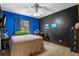 Bedroom featuring vibrant blue walls and black accent wall at 1032 Silcox Branch Cir, Oviedo, FL 32765
