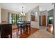 Inviting dining room featuring a window view, chandelier, and hardwood flooring at 1032 Silcox Branch Cir, Oviedo, FL 32765