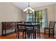 Inviting dining room featuring a window view, chandelier, and hardwood flooring at 1032 Silcox Branch Cir, Oviedo, FL 32765