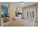 Inviting entryway with neutral tile flooring, leading to the kitchen and adorned with a bright blue rug at 1032 Silcox Branch Cir, Oviedo, FL 32765