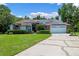 Charming single-story home with solar panels, lush landscaping, and a two-car garage at 1032 Silcox Branch Cir, Oviedo, FL 32765