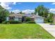 Charming single-story home with solar panels, lush landscaping, and a two-car garage at 1032 Silcox Branch Cir, Oviedo, FL 32765
