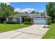 Charming single-story home with solar panels, lush landscaping, and a two-car garage at 1032 Silcox Branch Cir, Oviedo, FL 32765