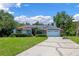 Charming single-story home with solar panels, lush landscaping, and a two-car garage at 1032 Silcox Branch Cir, Oviedo, FL 32765