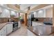 Well-lit kitchen with stainless steel appliances, white cabinets and tile floors at 1032 Silcox Branch Cir, Oviedo, FL 32765
