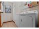 Functional laundry room with white washer and dryer and wire shelving at 1032 Silcox Branch Cir, Oviedo, FL 32765