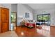Bright living room with hardwood floors, couch and views of the lanai and pool at 1032 Silcox Branch Cir, Oviedo, FL 32765