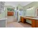 Bright bathroom with dual sinks, vanity, bathtub, and enclosed shower at 1032 Silcox Branch Cir, Oviedo, FL 32765