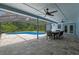 Inviting covered patio with dining set and view of the pool and lush landscaping at 1032 Silcox Branch Cir, Oviedo, FL 32765