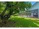 Secluded backyard featuring an expansive pool, mature trees, a screened lanai, and lush landscaping at 1032 Silcox Branch Cir, Oviedo, FL 32765