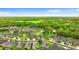 Beautiful aerial view of a lovely home nestled in a lush green neighborhood under a clear blue sky at 1035 Stoney Creek Dr, Lakeland, FL 33811