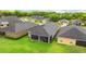 Aerial view of the house showcases backyard, screened patio and well-maintained lawn at 1035 Stoney Creek Dr, Lakeland, FL 33811